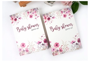 Floral baby shower game cards detail with elegant watercolor patterns on a white table