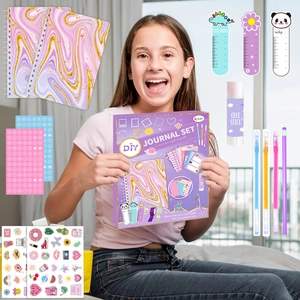 Detail view of purple DIY journal set with glitter stickers, pens, and marble notebooks