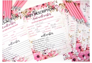 Macro shot of floral baby shower prediction cards with pink pencils on white background