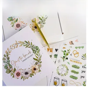 Detailed wedding guest book set with gold diamond pen and floral decorative stickers