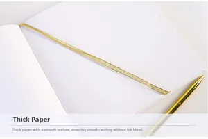 Detail of premium thick white paper and elegant gold ribbon bookmark with metal pen