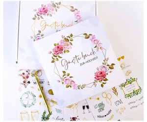 Wedding guest book set with gold pen, floral stickers, and a matching gift box