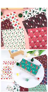 Detailed view of Christmas scrapbook paper set with Santa and reindeer festive patterns