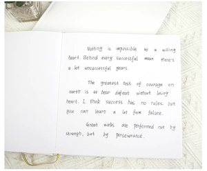 Detail view of smooth white inner pages of a DIY wedding guestbook with handwritten notes