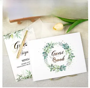Detailed wedding guest book set with gold pen, instructional card and botanical cover design