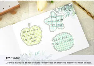 Detail of DIY wedding guest book stickers with gold foil phrases and adhesive dots