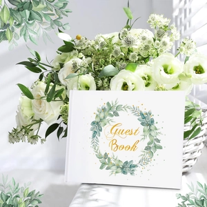 Elegant white wedding guest book with gold foil lettering and green watercolor wreath cover
