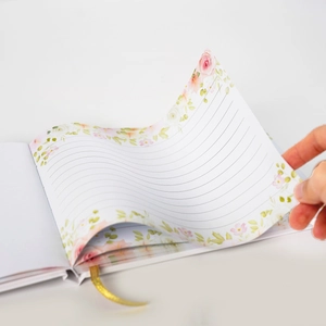 Detail van de bloemrijke binnenpagina's met gouden zijden bladwijzer en lijntjes