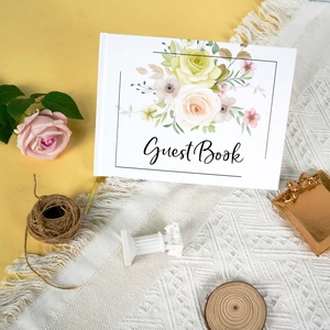 Detailweergave van een bloemig bruiloft gastenboek met gouden folie belettering