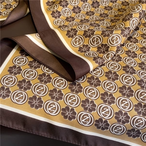 Detailed close-up of premium silk scarf featuring retro floral patterns and rich earthy tones