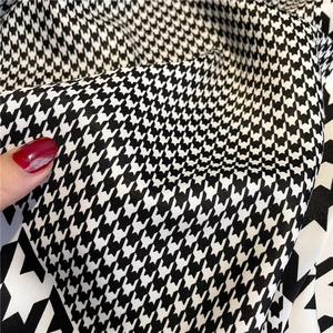 Close-up detail of classic black and white houndstooth twill fabric for scarves
