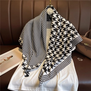 Classic black and white houndstooth twill silk scarf draped on a white shirt