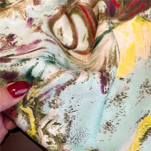 Detail shot of oil painting style silk scarf with vibrant twill texture and colors