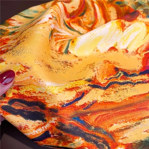 Macro detail of artistic oil painting silk scarf with vibrant yellow satin texture