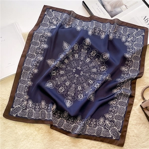 Detailed view of square silk scarf with vintage paisley print and navy blue finish