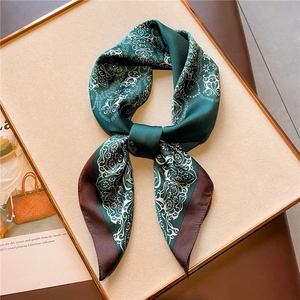 Detail of silk-feel scarf with paisley patterns in a vintage gold display frame