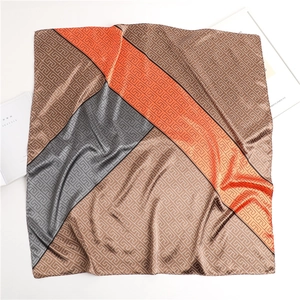 Macro detail of satin scarf showing geometric maze pattern and fine rolled hem edges