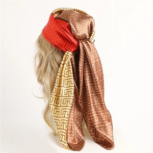 Ethnic geometric pattern satin silk scarf tied as headband in brown and orange