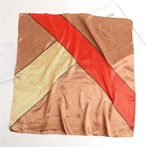 Detail of geometric satin scarf with red, yellow and brown color-blocking pattern
