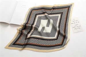 Macro detail of pleated houndstooth scarf with geometric patterns and soft folds