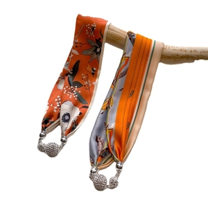 Silk scarf necklace with orange floral patterns and silver magnetic diamond clasp