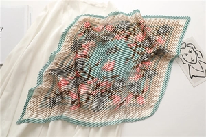 Detail of floral pleated silk scarf with accordion texture and elegant green pink patterns