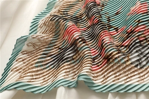 Detailed macro view of vintage chain floral print on accordion pleated silk scarf