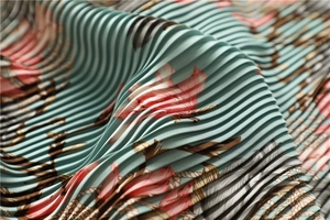 Close-up of pleated silk scarf featuring pink floral print on a mint green background