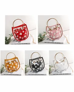 Detail display of clear PVC mini tote bags with daisy inner pouches in multiple colors