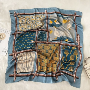 Macro detail of silk scarf featuring elegant bird illustrations and geometric patterns