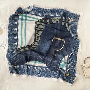 Detail of emerald green silk scarf featuring vintage chain prints and boot motifs