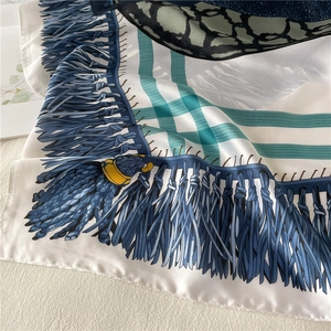 Close-up of elegant emerald silk scarf with luxury lace patterns and soft drapery texture