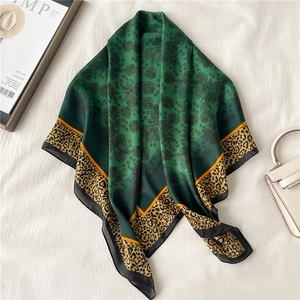 Elegant emerald green silk scarf with floral patterns and leopard print borders