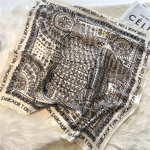 Retro ethnic style silk scarf with elephant print and letter border on plush white rug