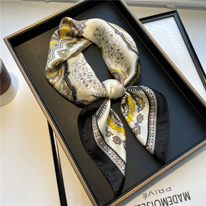 Elegant silk scarf with vintage paisley pattern in yellow and white, lifestyle layout