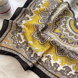 Elegant paisley print silk square scarf in yellow and brown on white plush background
