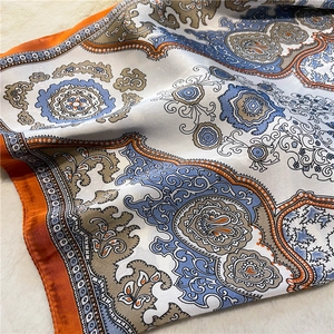 Detail of paisley silk scarf with orange border showing soft texture on faux fur
