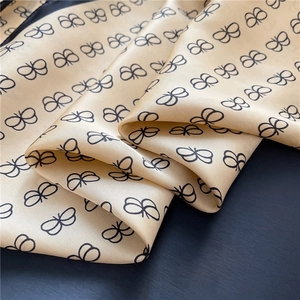 Close-up of silky 70cm square scarf with elegant black butterfly prints and gloss texture