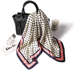 Elegant silk-like square scarf with black polka dots and contrasting pink and navy borders