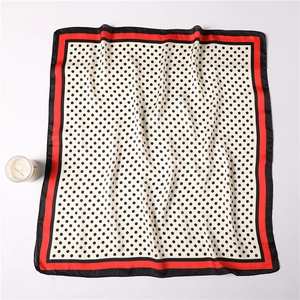 Close-up of silk-feel square scarf with polka dot print and red border details
