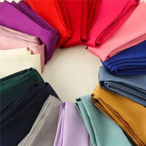 Macro shot of colorful silk scarves arranged in a circle showing smooth texture