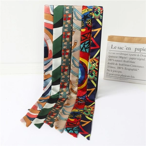 Vertical display of six printed silk scarves with geometric and chain patterns