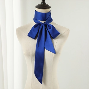 Detail view of a navy blue satin silk scarf tied in a bow on a mannequin stand