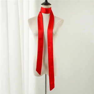 Detail of a vibrant red satin skinny scarf tied on a mannequin neck with silky texture