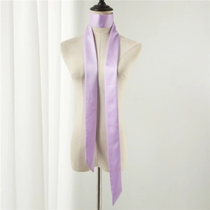 Detail of lavender satin skinny scarf tied on a mannequin showing silky texture and pointed ends