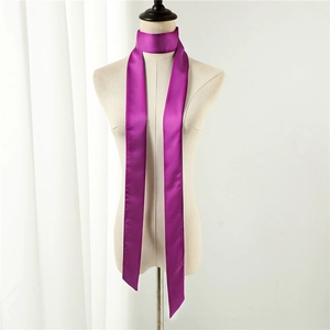 Detail of vibrant violet satin skinny scarf tied elegantly on a mannequin neck