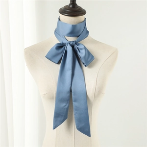 Elegant misty blue satin skinny scarf tied in a bow on a mannequin neck display