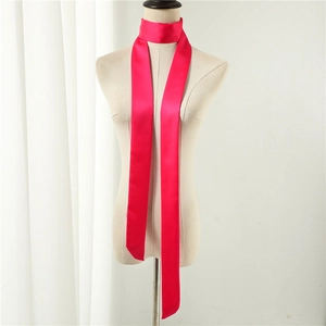 Macro detail of glossy rose pink satin silk ribbon scarf on mannequin neck