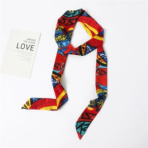 Detail view of colorful geometric print silk scarf with red, yellow and blue patterns