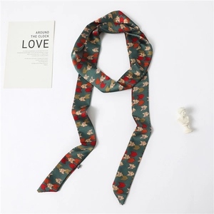 Detail of dark green geometric arrow print silk twilly scarf with a satin glossy finish